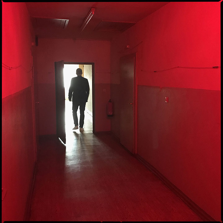 man walks through doorway in Former Stasi prison in Berlin