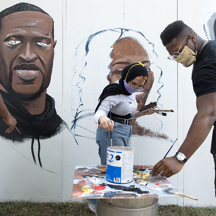Participants paint murals in honor of Black Lives Matter