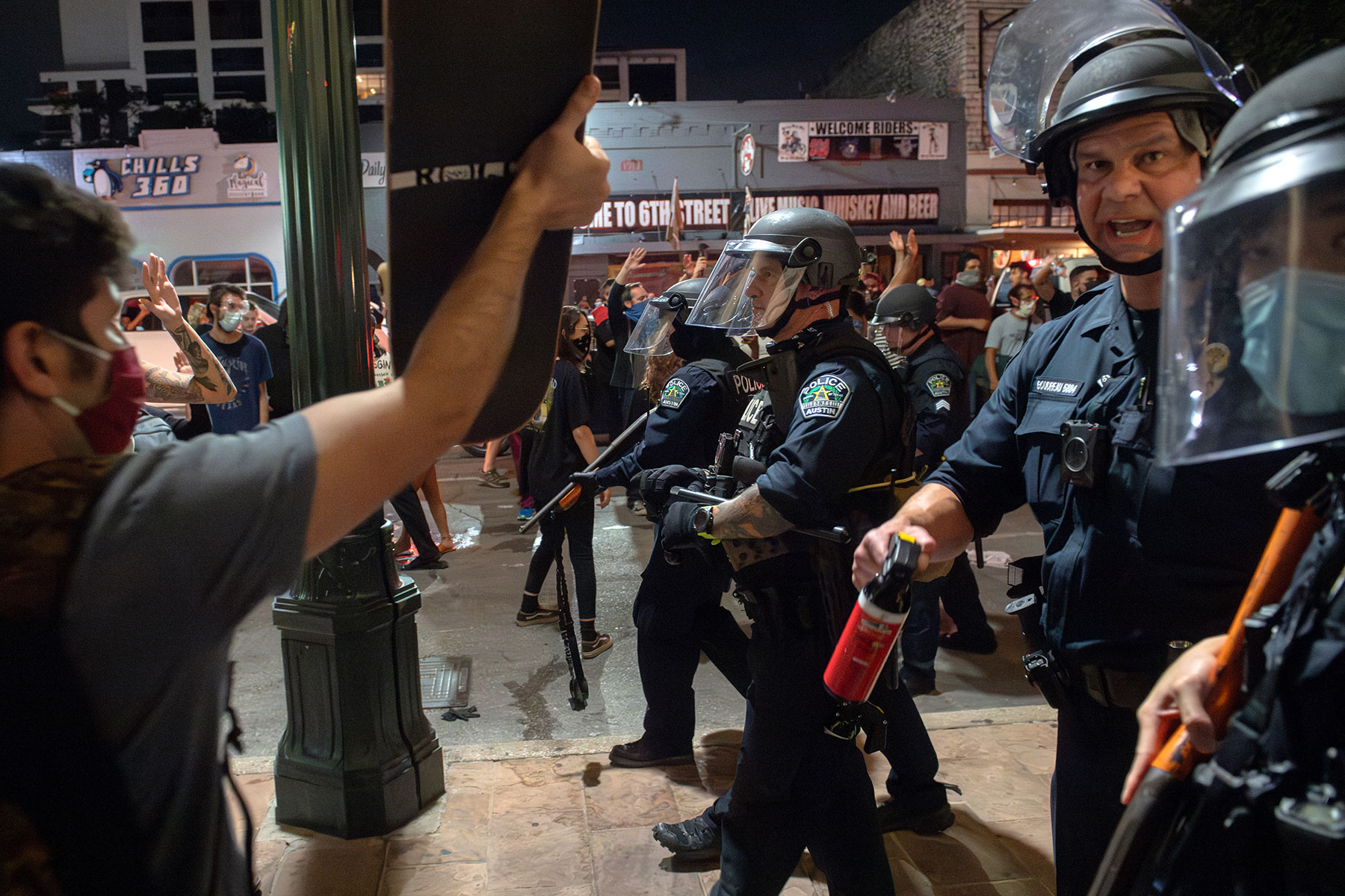 Police clear Sixth Street in Austin, Texas as protesters march through the downtown entertainment district