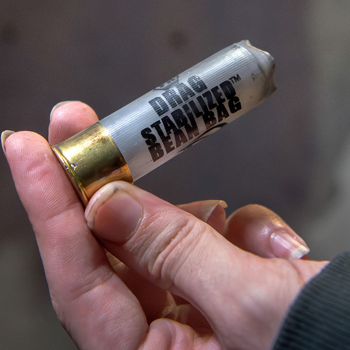 A protester holds the spent shell of a baton round or “bean bag” found on the ground outside police department headquarters