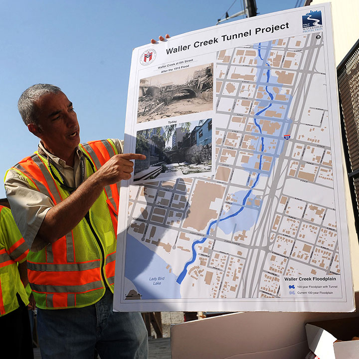 A construction worker displays a map of the Waller Creek floodplain