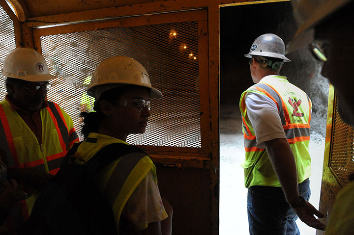 Workers and media representatives enter the Waller Creek tunnel construction site