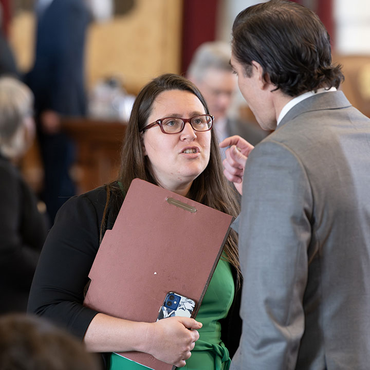 State Representative Erin Zwiener speaks with a colleague during the 88th Texas Legislature