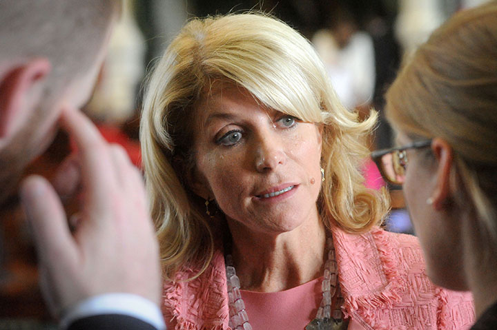 State Senator Wendy Davis speaks with colleagues during the 83th Texas Legislature on July 12, 2013.