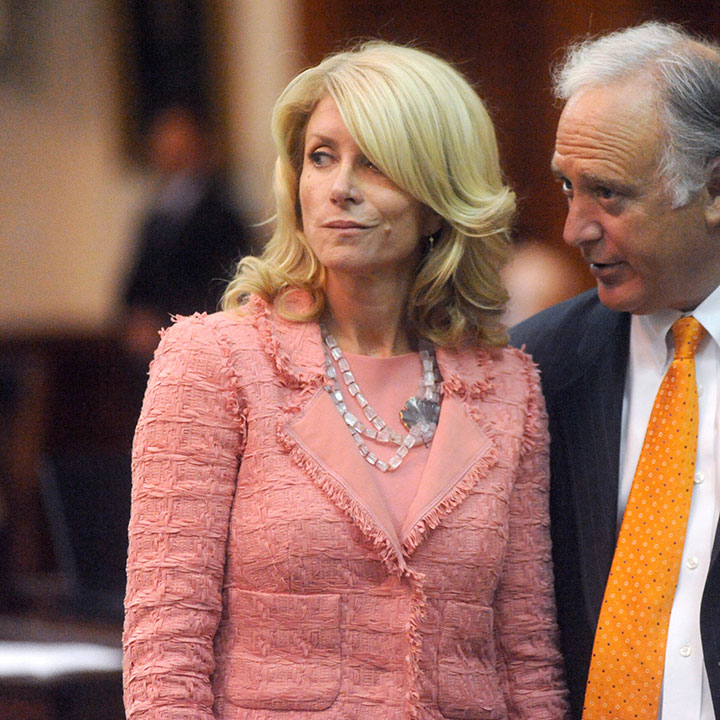 State Senators Wendy Davis and Kirk Watson converse on the Senate floor during the 83th Texas Legislature