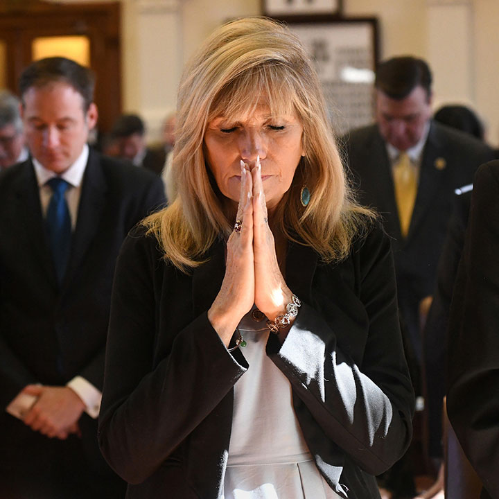 State Representatives pray during Opening Day proceedings for the 85th Texas Legislature