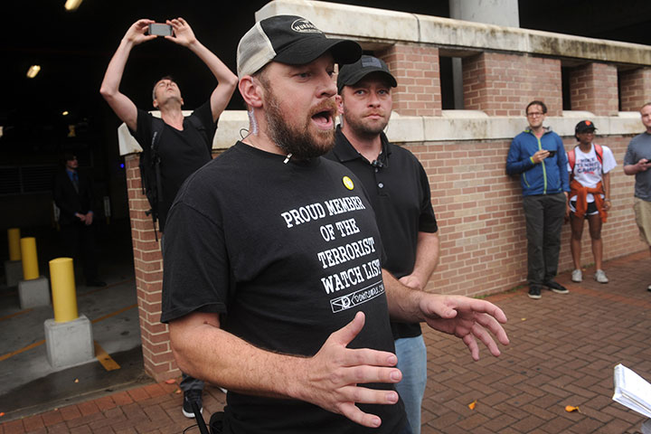 Gun rights activist and event organizer Murdoch Pizgatti speaks with a reporter during an open carry demonstration