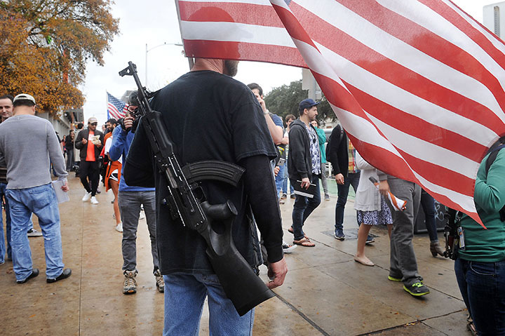 Gun rights activists march along The Drag next to the University of Texas